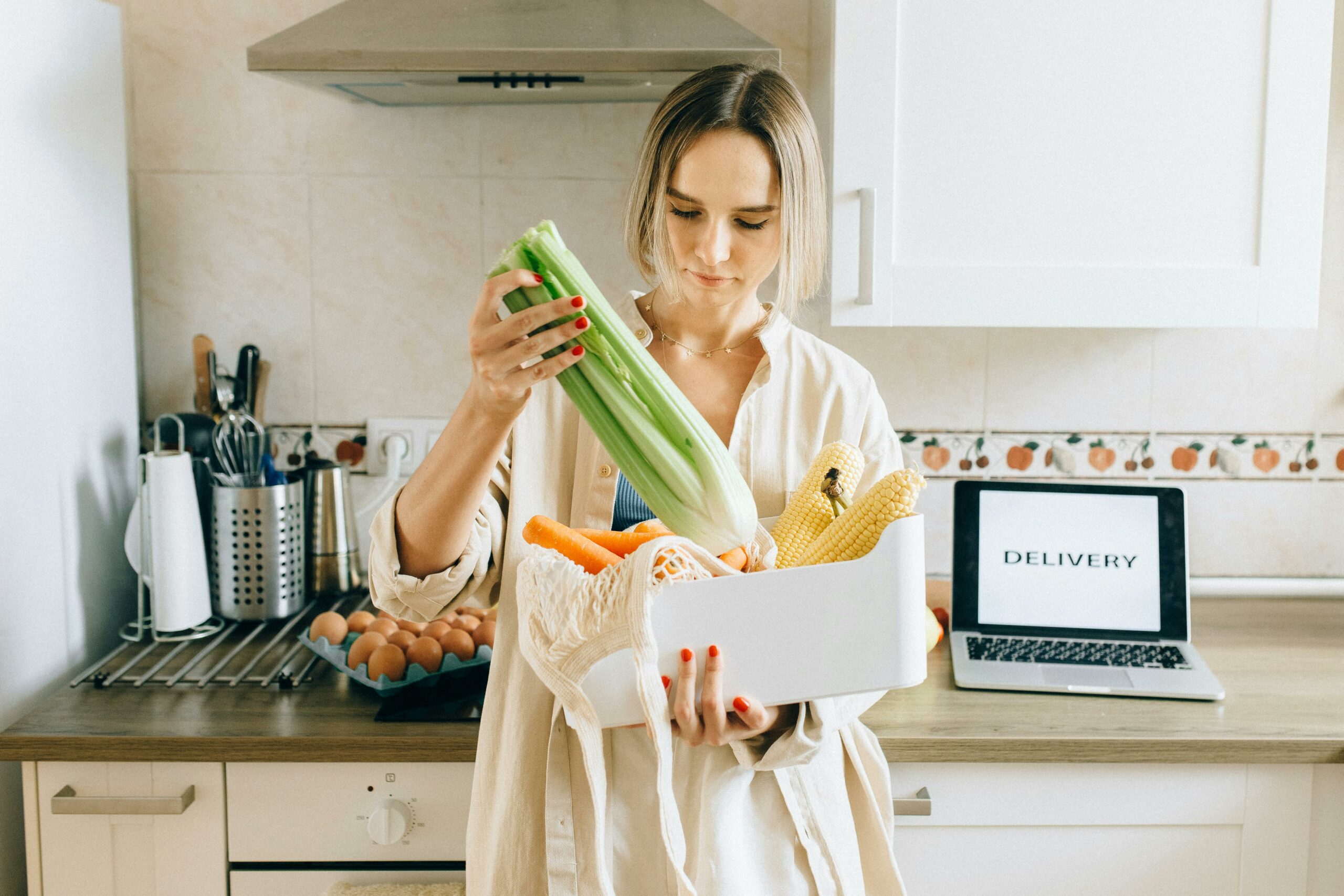 woman standing in the kitchen after ordering groceries online